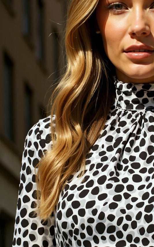 Animal print top with frilled high neck and long sleeve in black, white and grey