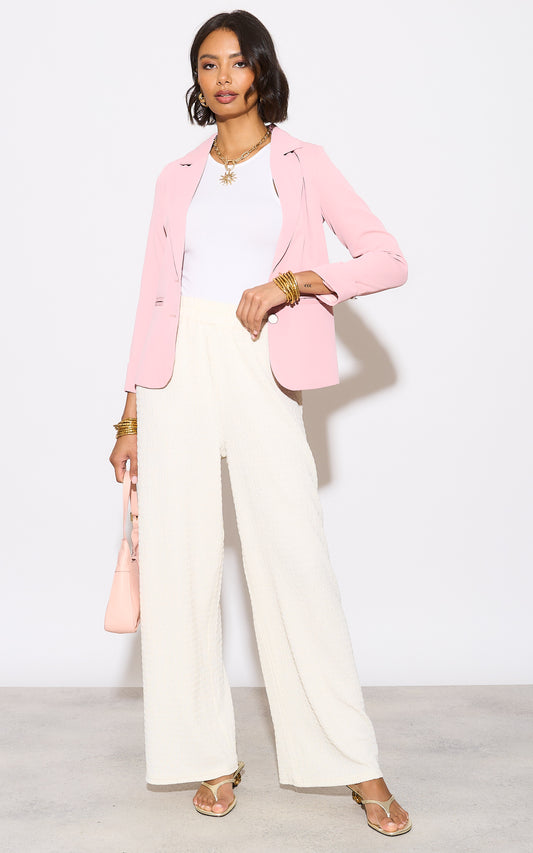Pink blazer with rolled-up sleeves